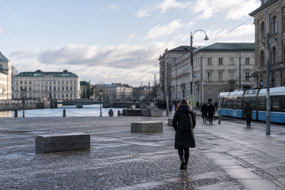 A Swedish long-distance train waiting at a platform beside Gothenburg Central Station on a bright morning