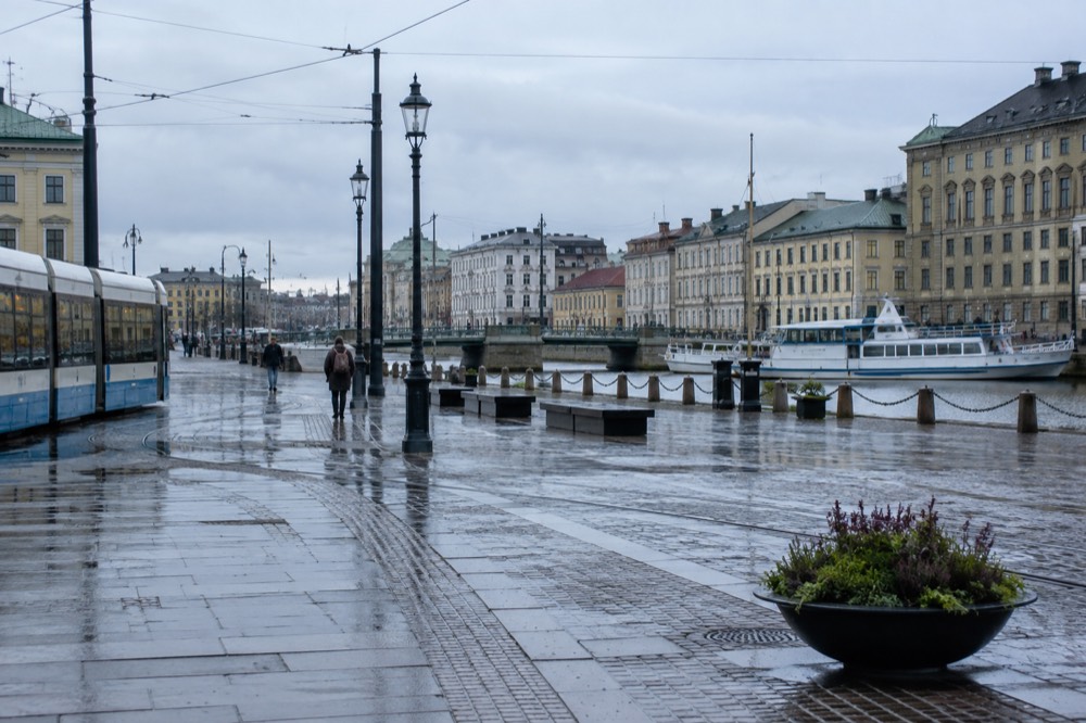 Gothenburg canal boats and painted wooden houses along the waterfront under a grey Nordic sky
