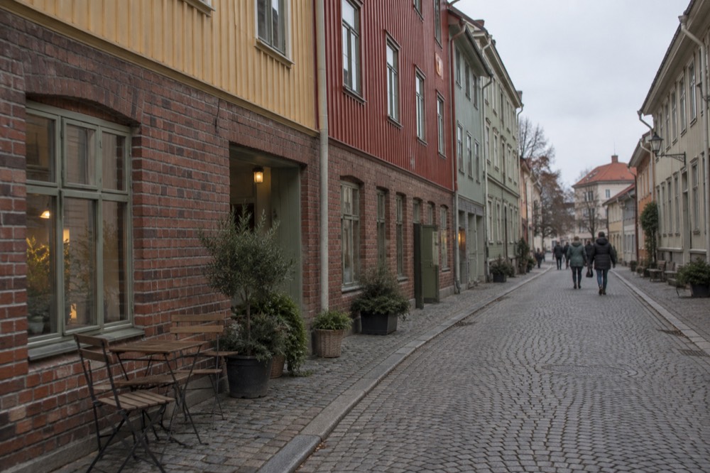 Wooden landshövdingehus houses painted in period colours along a cobbled street in the Haga quarter of Gothenburg