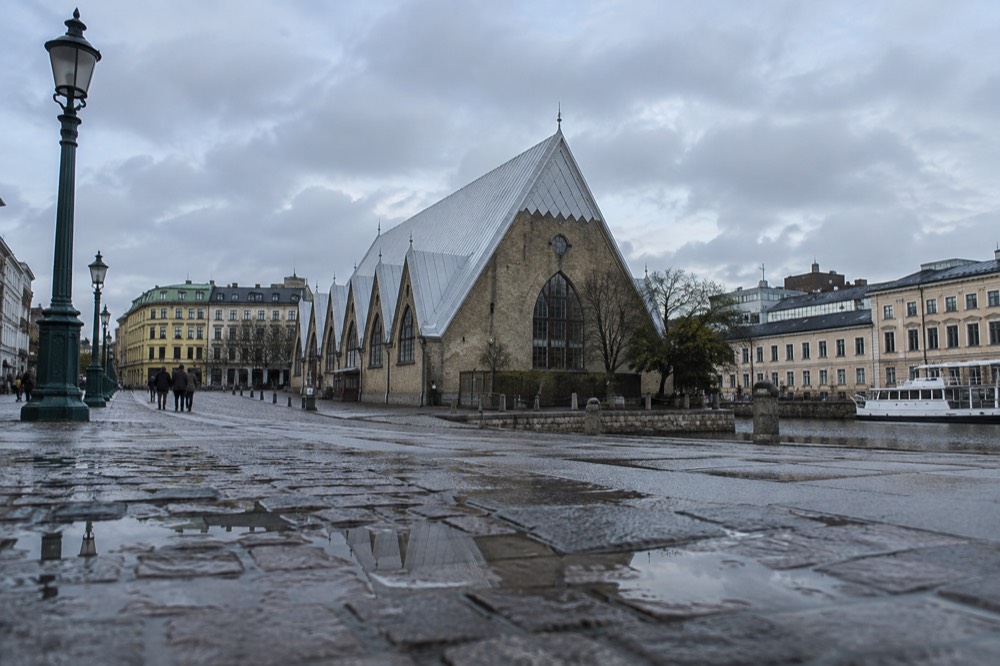 A wooden church-shaped market hall beside a canal in central Gothenburg