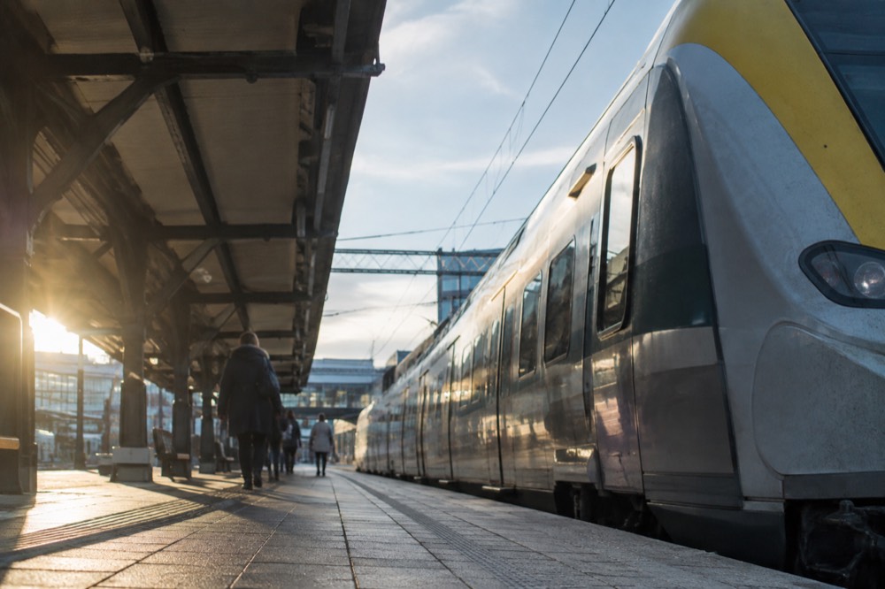 A Swedish regional train standing at a platform beside Gothenburg Centralstation on a bright morning