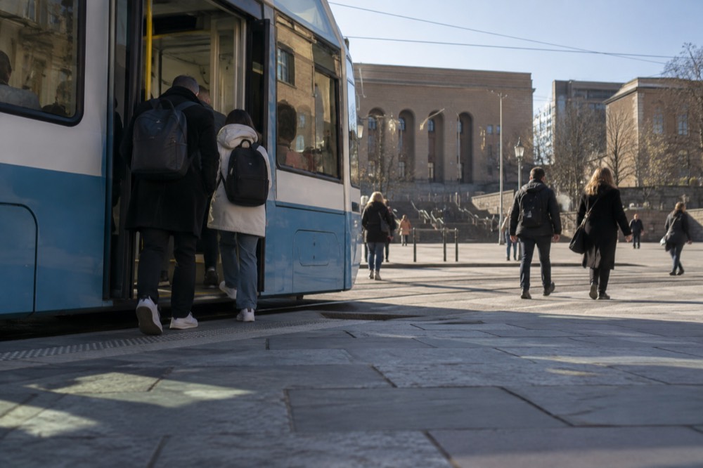 A Gothenburg tram in service on a street near Avenyn with passengers boarding