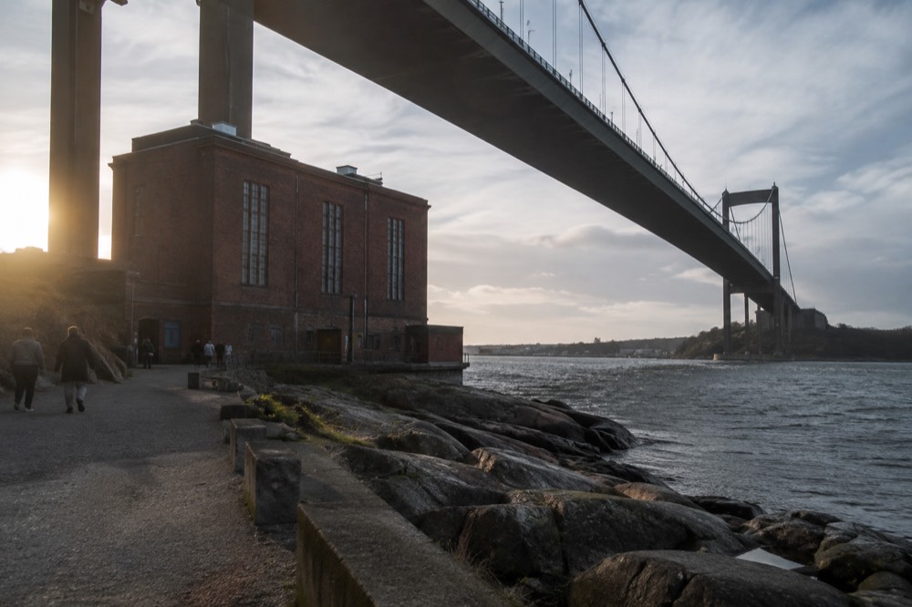 The Älvsborg Bridge seen from below with pedestrians on the riverside path