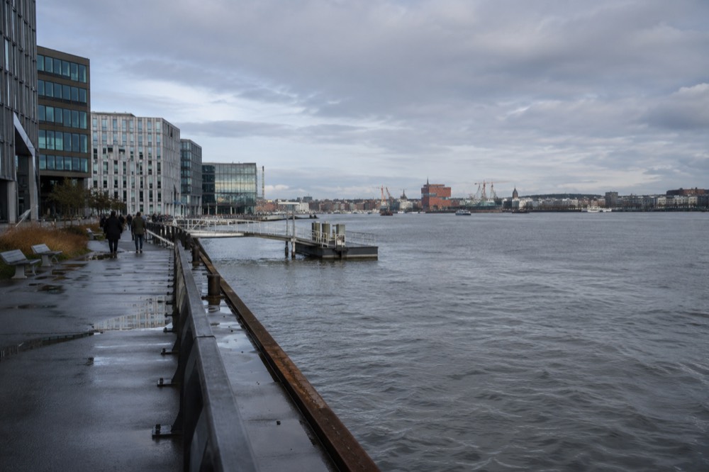 Riverside walking path on Hisingen with the Gothenburg city skyline across the water