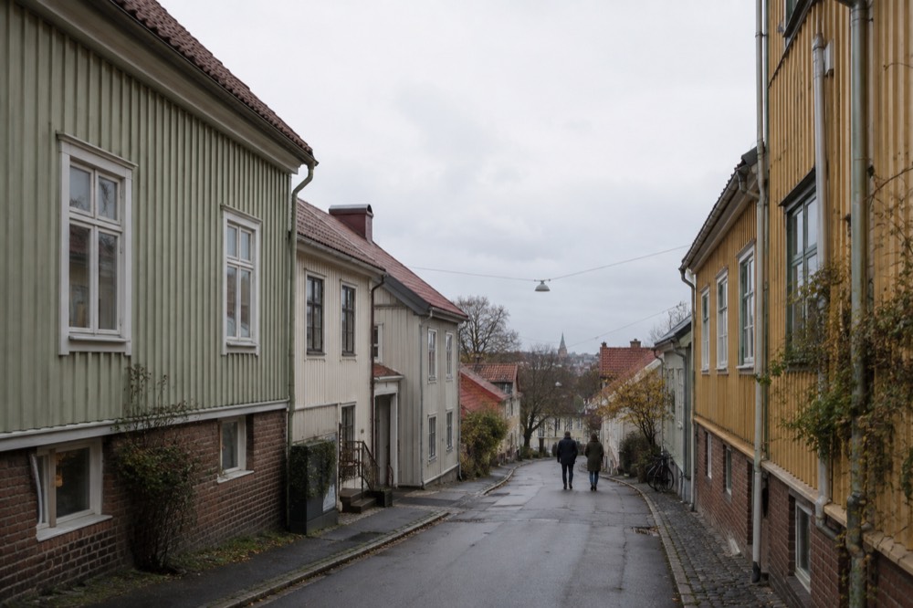 A narrow lane of small wooden houses with painted facades in Majorna