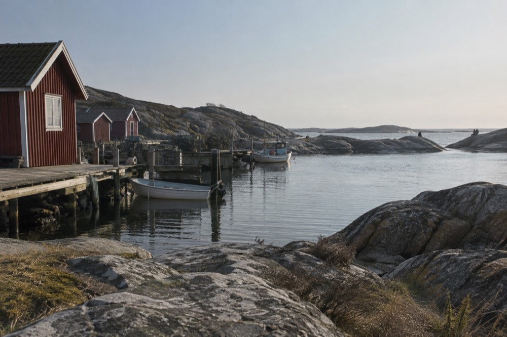 Granite rocks and a swimming bay on Vrångö island with flat sea beyond