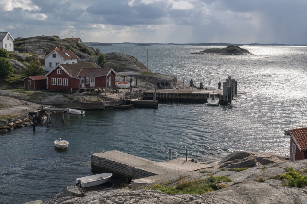 Rain shower passing over the archipelago with sunlit water between clouds
