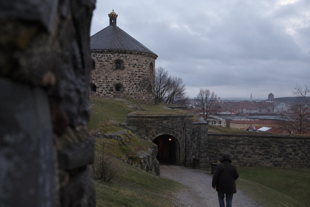 Stone gateway and grassy ramparts of the old fort in evening light