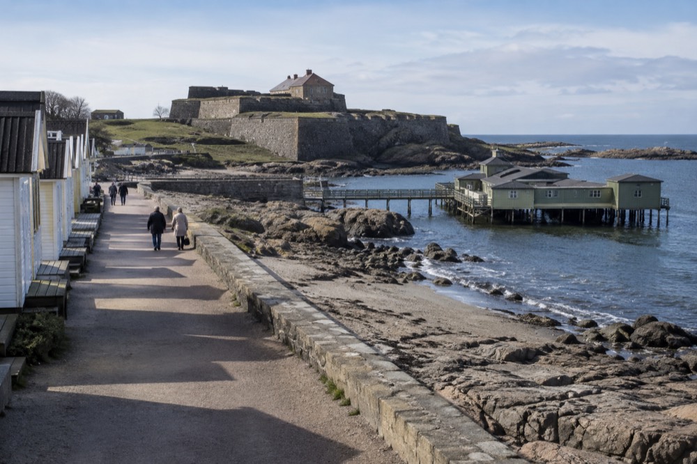 A coastal promenade at Varberg with the sea on one side and beach huts on the other