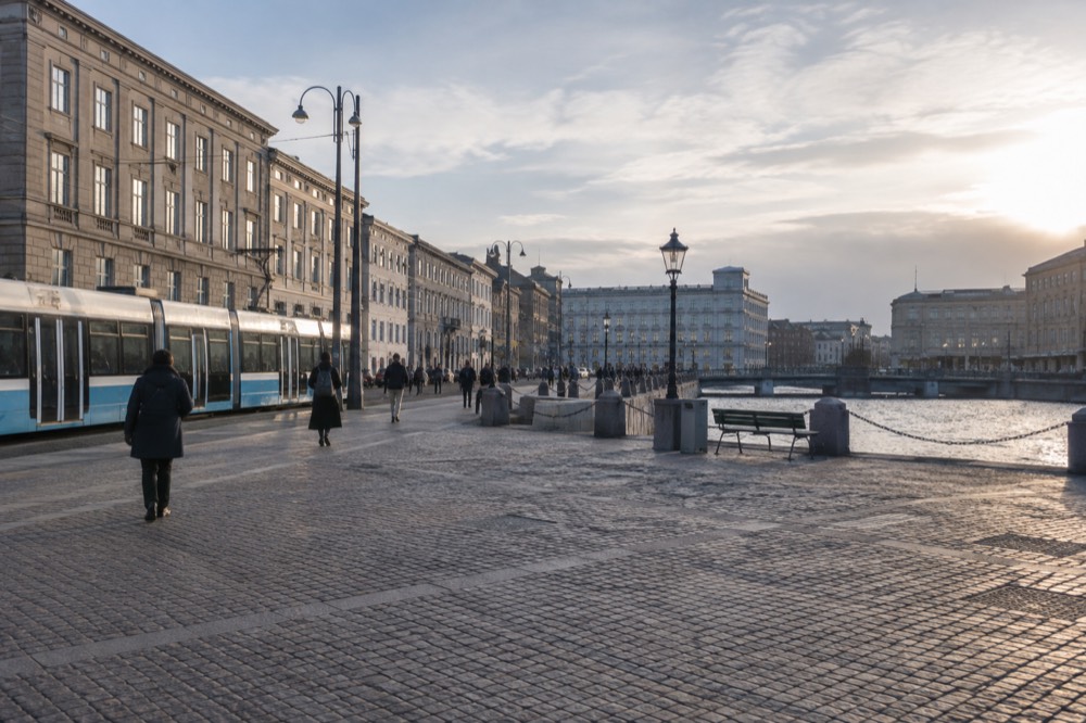 Tram on a Gothenburg street with stone buildings on both sides