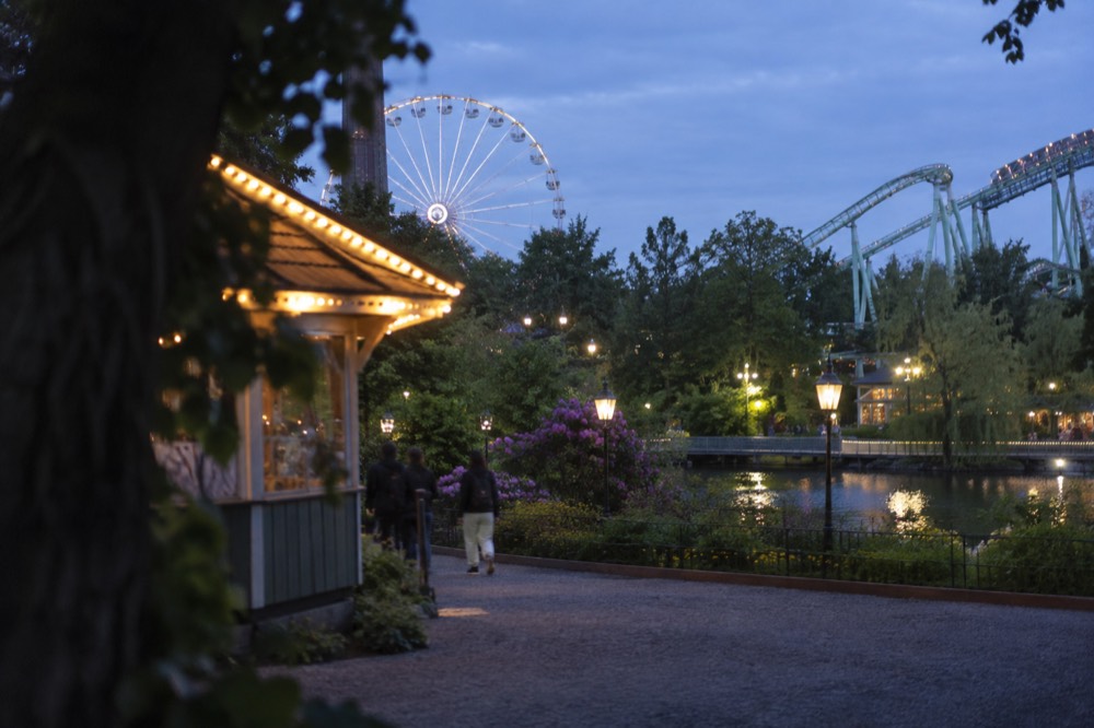 Ferris wheel and ride entrances at Liseberg amusement park on a spring day