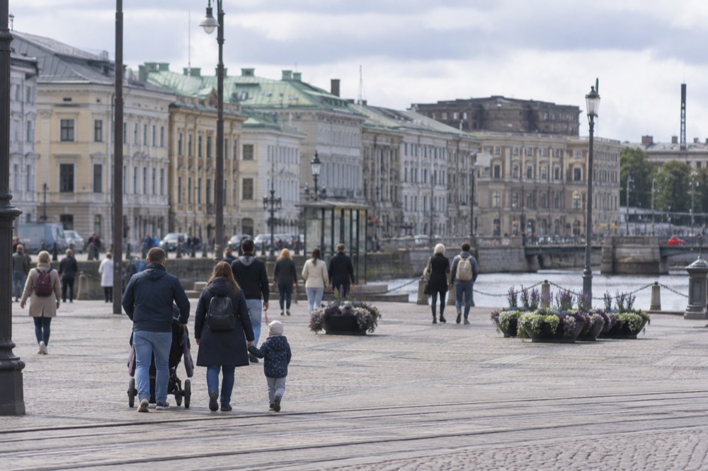Families walking through a park with animal enclosures in Gothenburg