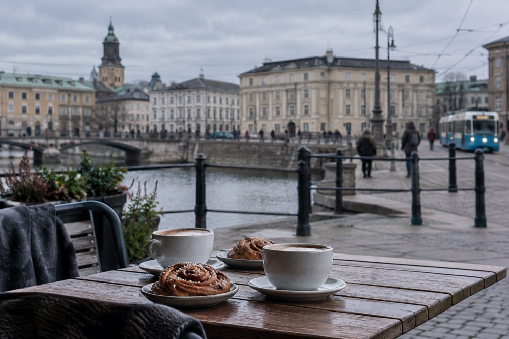 Coffee and cinnamon buns on a wooden cafe table in Gothenburg
