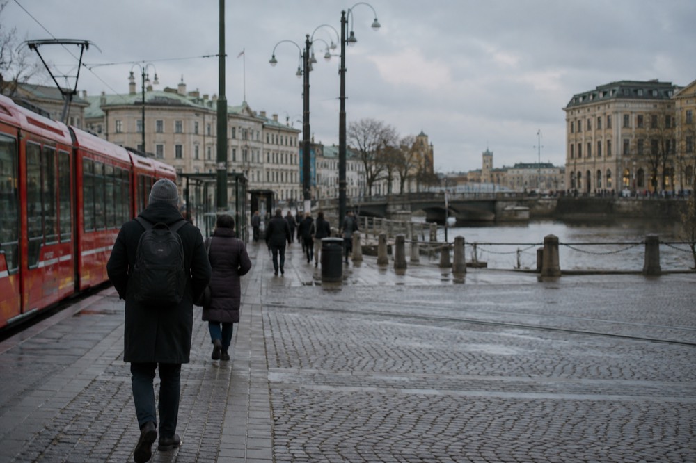 Red trams and a canal in central Gothenburg under a grey Nordic sky