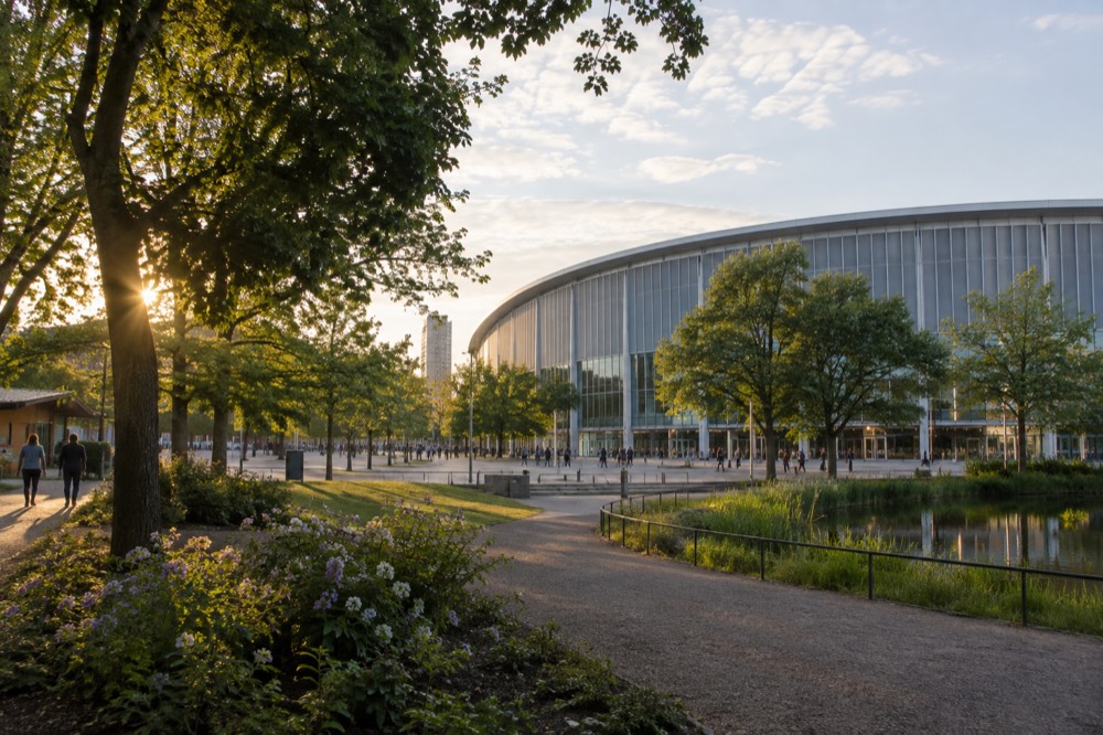 The exterior of the Scandinavium arena in Gothenburg with the Liseberg ferris wheel visible behind it