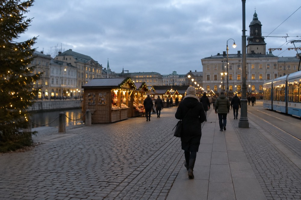 Christmas market stalls and lights at a Scandinavian square in early darkness