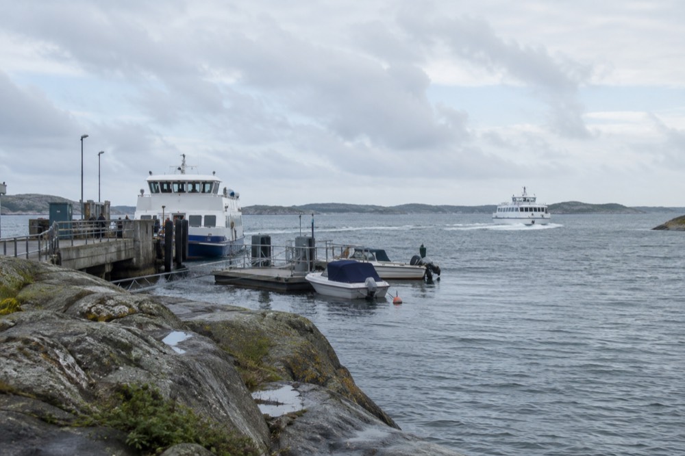 A ferry crossing open water toward green islands on the northern horizon near Gothenburg