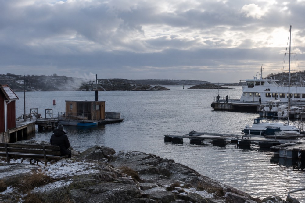 Steam rising from a sauna boat at anchor in a sheltered archipelago inlet
