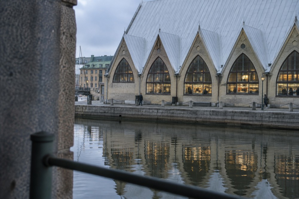 The wooden fish-church hall Feskekôrka seen from the canal, with market stalls visible inside