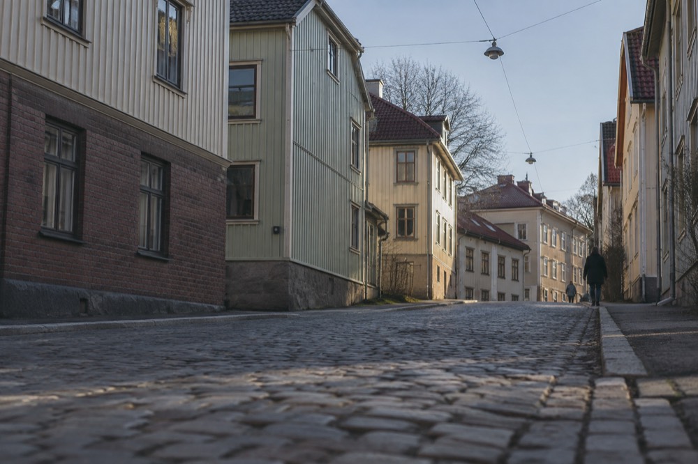 Painted wooden landshövdingehus houses on a cobbled hill in Majorna