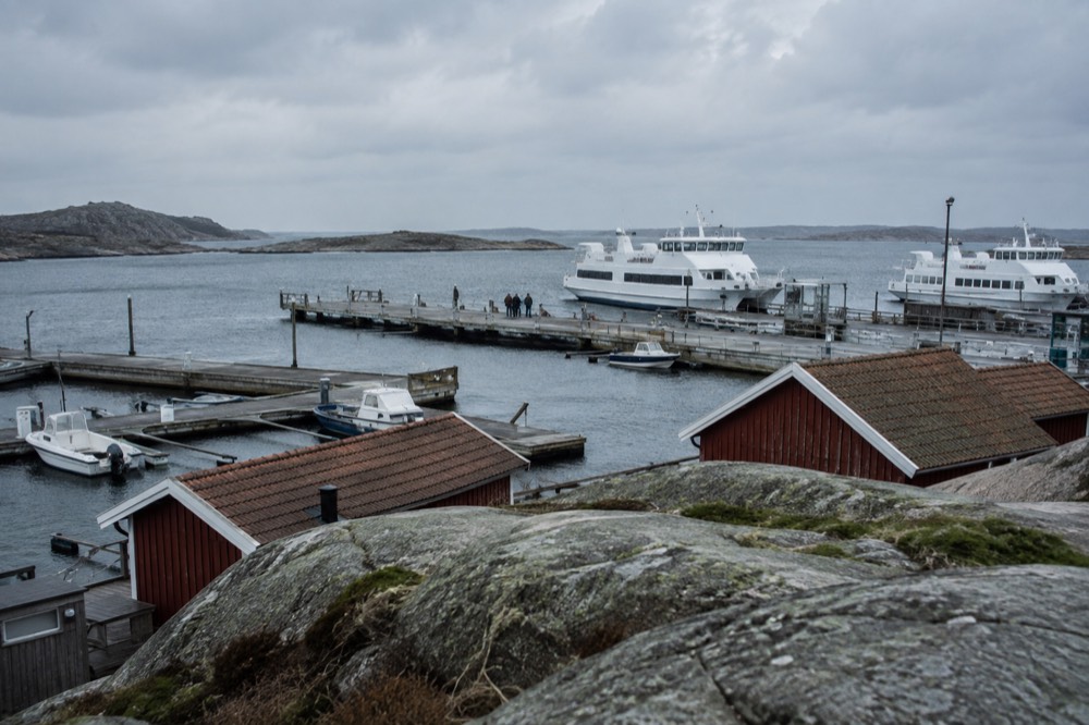Wooden boathouses and smooth granite rocks on a car-free archipelago island near Gothenburg