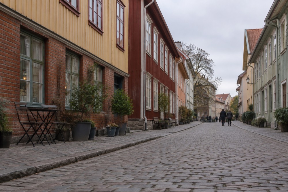 Wooden painted houses on a cobblestone street in Haga in morning light